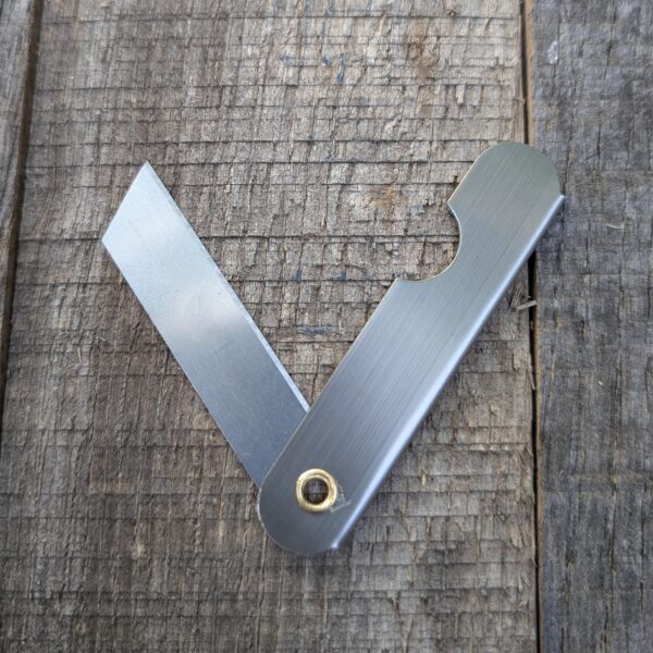 Razor knife open on wood