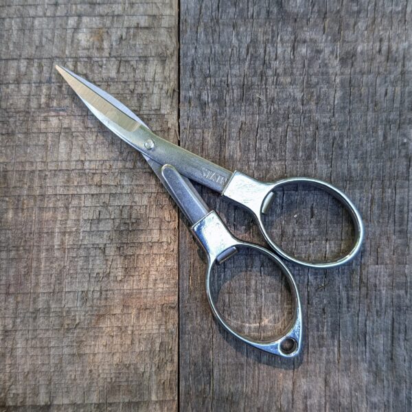 Folding Scissors open on wood